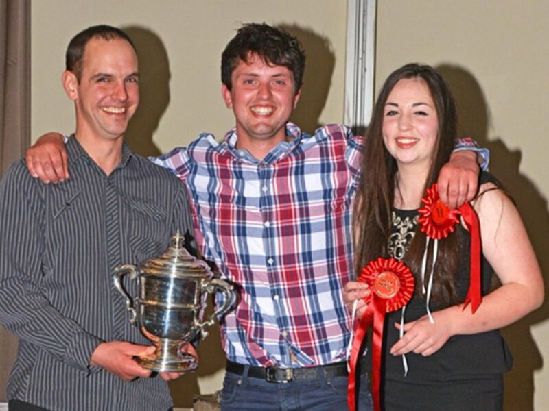Darland Trophy Winners - Asher Bradley Seddon (middle) and Evie Tomlinson receiving their trophy from Michael Broadley