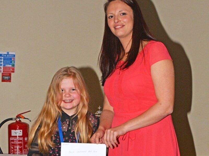 Anna Mortimer receiving her prize for the novice handler section from Jessica Miller